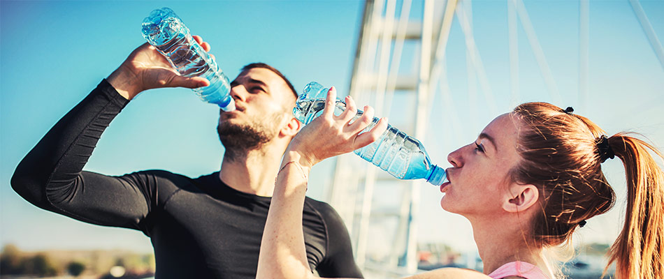 photo of a man and a woman drinking water